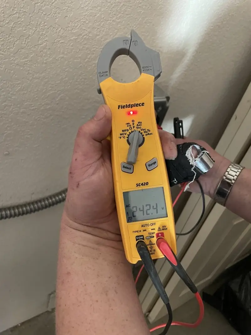 Voltage testing with clamp meter during Whole House Surge Protector in Eau Claire